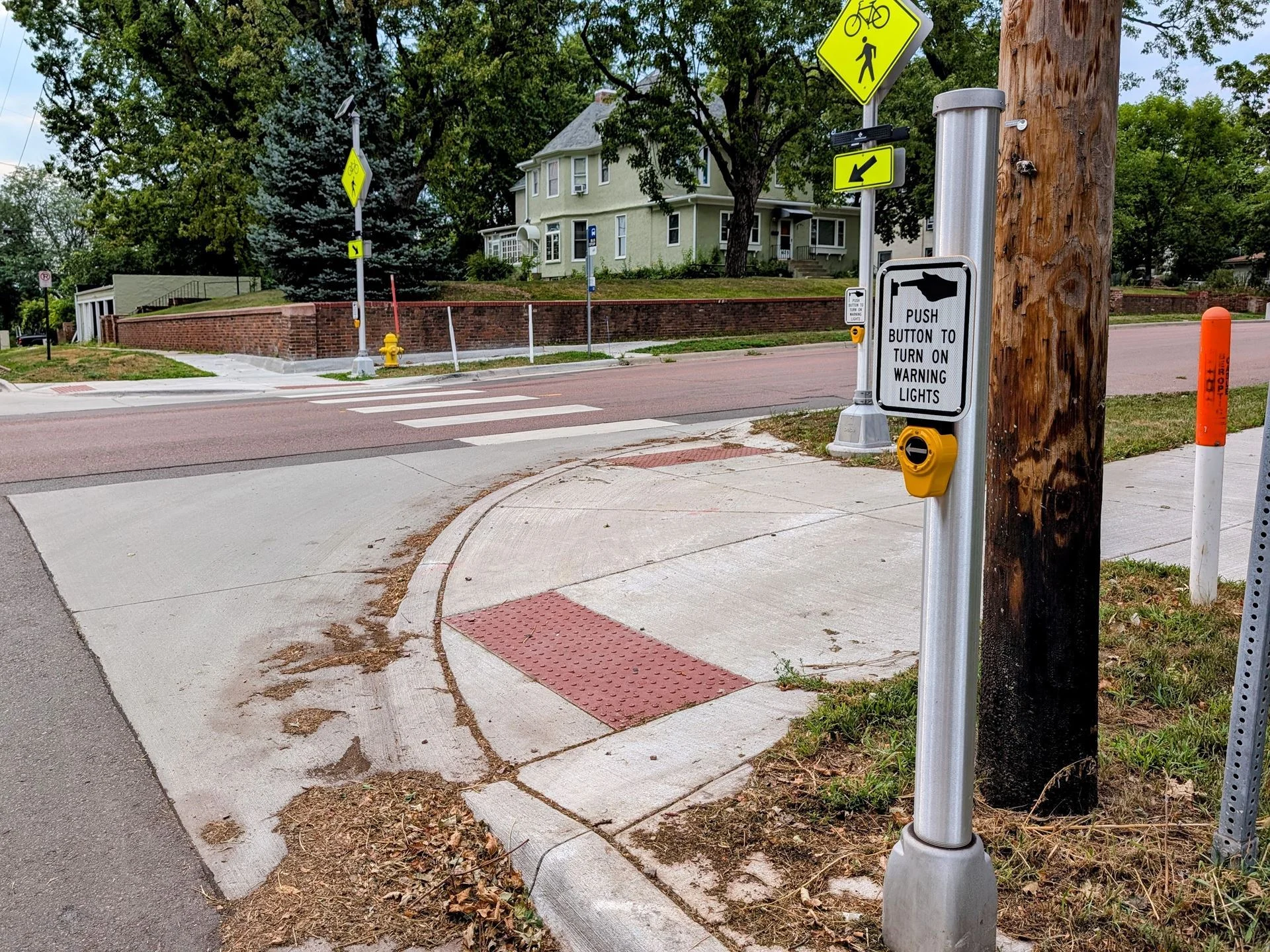 A curb side mounted button allow a bicyclist to active the flashers without leaving the roadway at the intersection of 15th Street and Grange Ave.